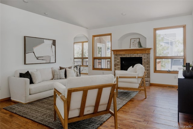1131 N 4th St, Johnstown, CO 80534 - living area featuring light wood-style floors and a fireplace