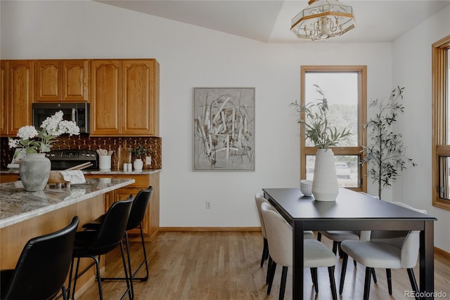 1131 N 4th St, Johnstown, CO 80534 - dining area with light wood-type flooring, plenty of natural light, and vaulted ceiling
