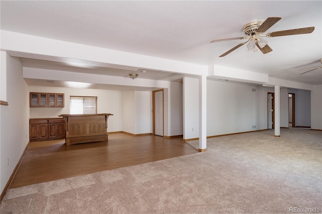 1131 N 4th St, Johnstown, CO 80534 - unfurnished living room with carpet, a ceiling fan, and bar
