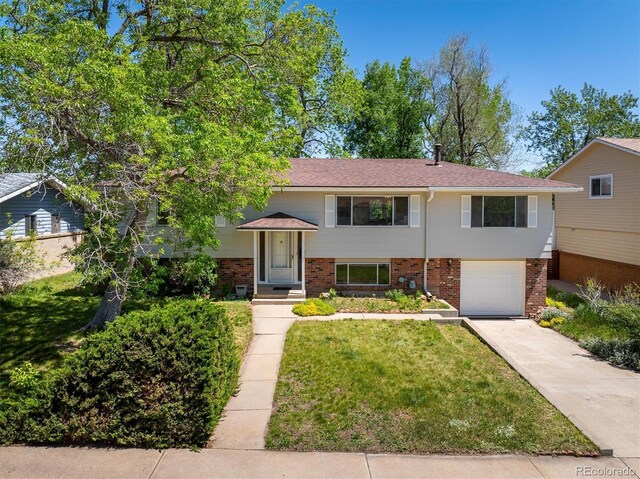 1270 Berea Dr, Boulder, CO 80305 - view of front of home with brick siding, driveway, an attached garage, and a front lawn