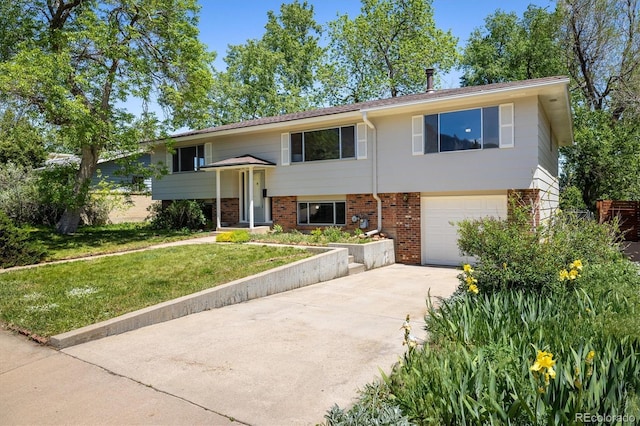 1270 Berea Dr, Boulder, CO 80305 - raised ranch featuring an attached garage, driveway, a front lawn, and brick siding