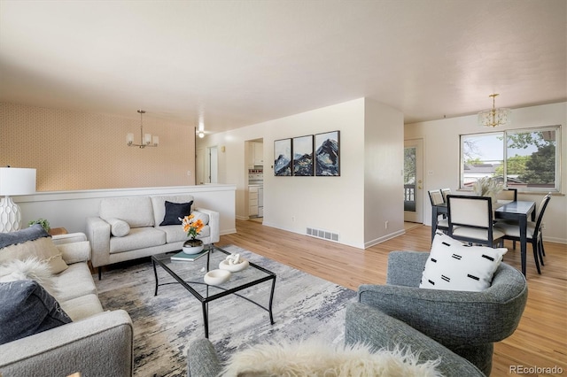 1270 Berea Dr, Boulder, CO 80305 - living area with a chandelier, light wood-style floors, baseboards, wallpapered walls, and an accent wall