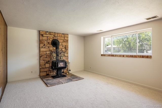1270 Berea Dr, Boulder, CO 80305 - unfurnished living room featuring a wood stove, carpet, a textured ceiling, and baseboards