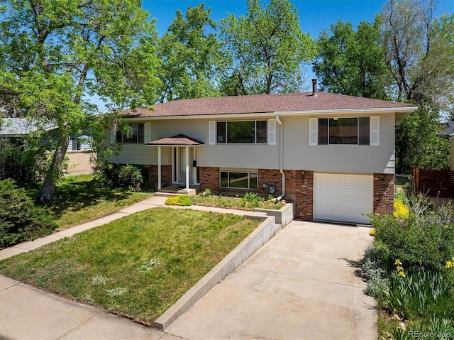 1270 Berea Dr, Boulder, CO 80305 - split foyer home with an attached garage, concrete driveway, a front yard, and brick siding