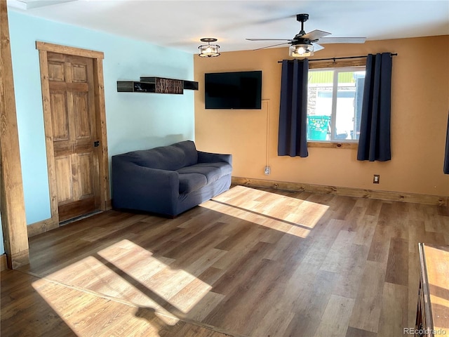 living room featuring ceiling fan and hardwood / wood-style floors