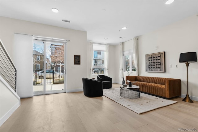 living area with wood finished floors and a healthy amount of sunlight