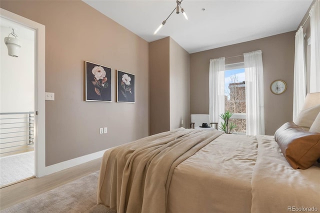 bedroom featuring baseboards and light wood-style flooring