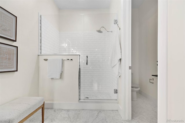 full bath with toilet, baseboards, marble finish floor, and a stall shower