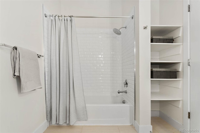 bathroom with shower / bathtub combination with curtain, baseboards, and tile patterned flooring