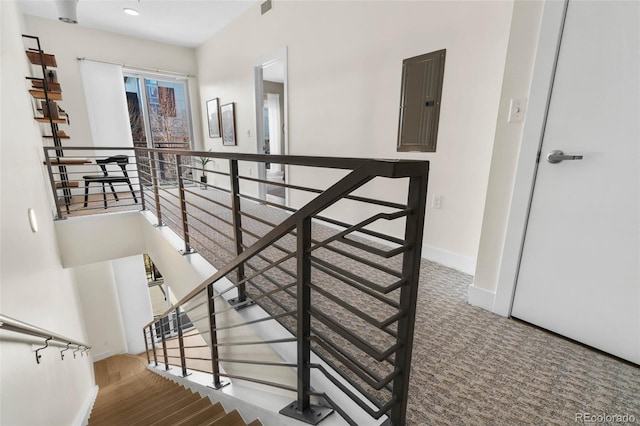 2530 Lawrence St Unit Ra101, Denver, CO 80205 - stairs with electric panel, carpet floors, and baseboards