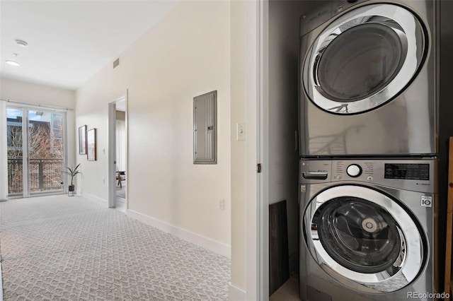 2530 Lawrence St Unit Ra101, Denver, CO 80205 - clothes washing area with stacked washer and clothes dryer, carpet flooring, electric panel, visible vents, and baseboards