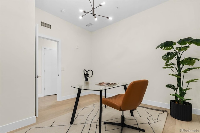 2530 Lawrence St Unit Ra101, Denver, CO 80205 - office area with light wood-style flooring, a chandelier, and baseboards
