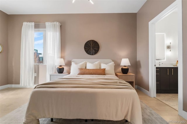 2530 Lawrence St Unit Ra101, Denver, CO 80205 - bedroom with light wood-type flooring, baseboards, and ensuite bath