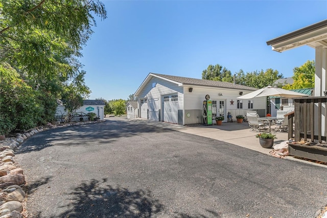 6480 W 60th Ave, Arvada, CO 80003 - back of house featuring a garage, an outdoor structure, and a patio area