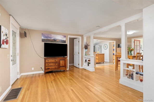 6480 W 60th Ave, Arvada, CO 80003 - living room with ornate columns, light wood-style flooring, and baseboards