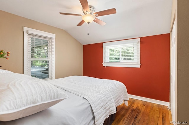6480 W 60th Ave, Arvada, CO 80003 - bedroom featuring vaulted ceiling, wood finished floors, baseboards, and ceiling fan