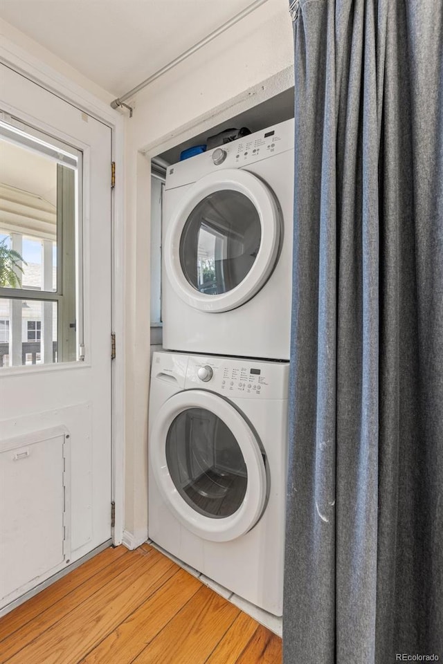 6480 W 60th Ave, Arvada, CO 80003 - laundry area with stacked washer and clothes dryer and light wood finished floors