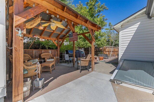 6480 W 60th Ave, Arvada, CO 80003 - view of patio featuring a fenced backyard, ceiling fan, a gazebo, and an outdoor living space