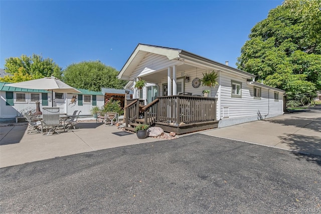 6480 W 60th Ave, Arvada, CO 80003 - view of front of house with a porch and a patio area