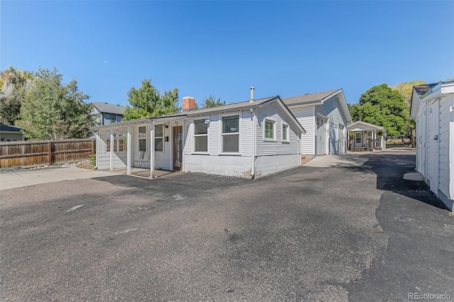6480 W 60th Ave, Arvada, CO 80003 - view of front of property with fence and a chimney