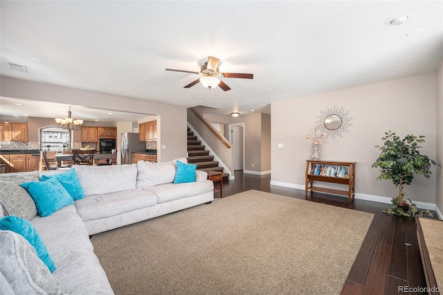 living area with stairs, visible vents, baseboards, and dark wood-style flooring