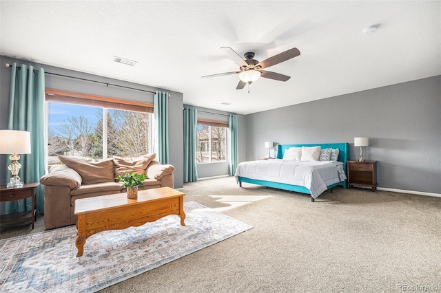 carpeted bedroom with a ceiling fan, baseboards, and visible vents