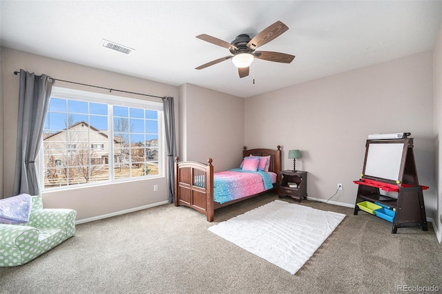 carpeted bedroom featuring visible vents, a ceiling fan, and baseboards