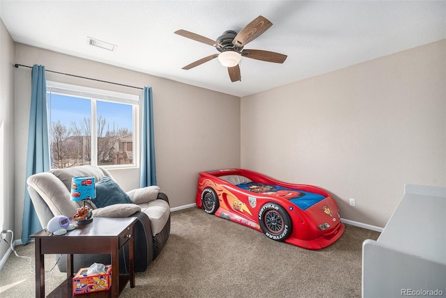 carpeted bedroom featuring visible vents, a ceiling fan, and baseboards