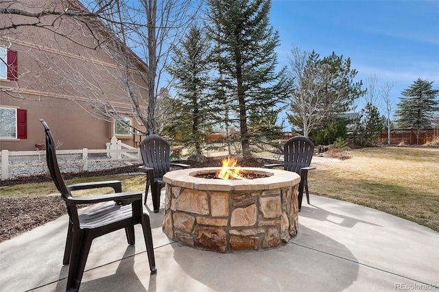 view of patio / terrace with a fire pit and fence