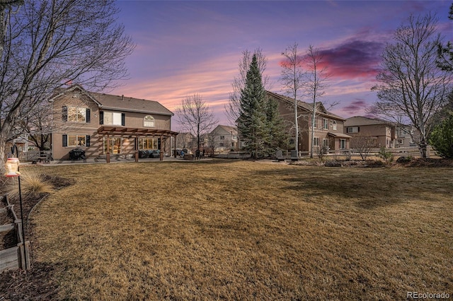 yard at dusk with a patio area