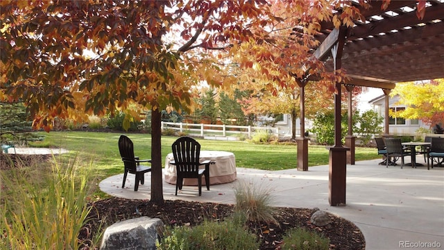 view of patio with outdoor dining space, a pergola, and fence