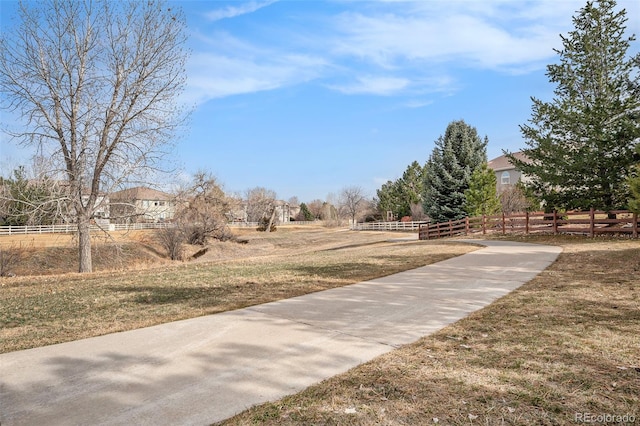 surrounding community with a rural view and fence