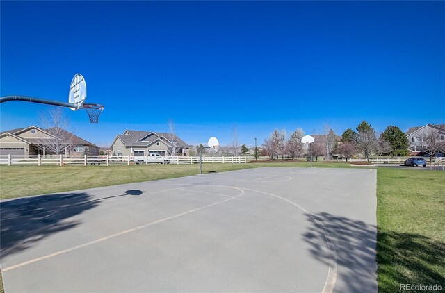 view of basketball court with community basketball court, a yard, and fence