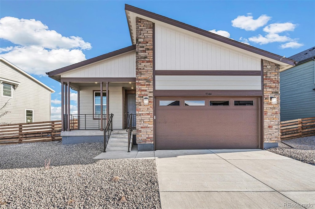 view of front of property featuring covered porch and a garage