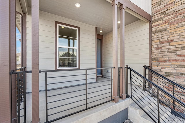 view of exterior entry featuring covered porch