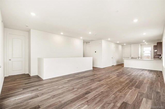 unfurnished living room featuring dark wood-type flooring