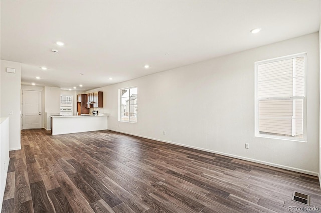 unfurnished living room featuring dark wood-type flooring