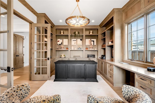 interior space featuring built in desk, built in shelves, light wood finished floors, an inviting chandelier, and recessed lighting