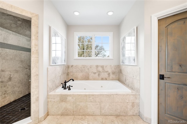full bathroom featuring a jetted tub, tile patterned flooring, and a stall shower