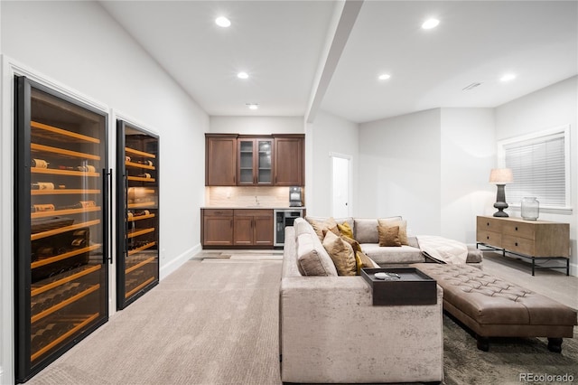 living area with recessed lighting, beverage cooler, light carpet, and indoor bar