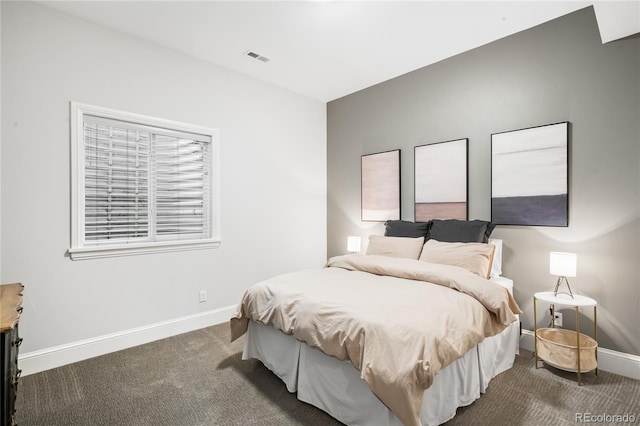 bedroom featuring baseboards, visible vents, and carpet