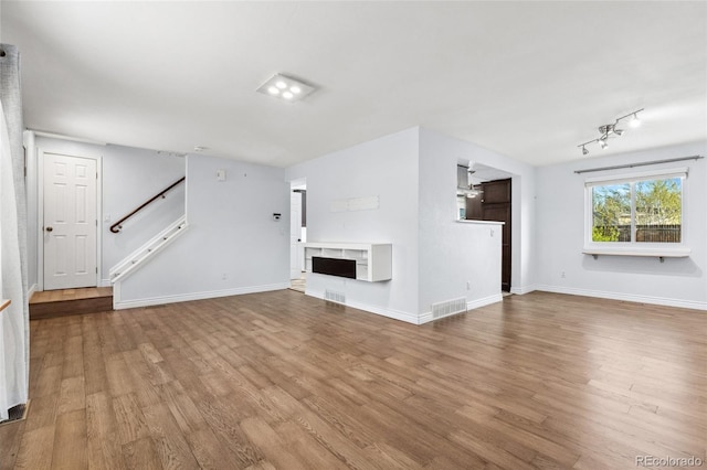 4860 S Field Way, Littleton, CO 80123 - unfurnished living room with stairway and wood finished floors