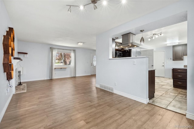 4860 S Field Way, Littleton, CO 80123 - unfurnished living room featuring rail lighting and light wood finished floors