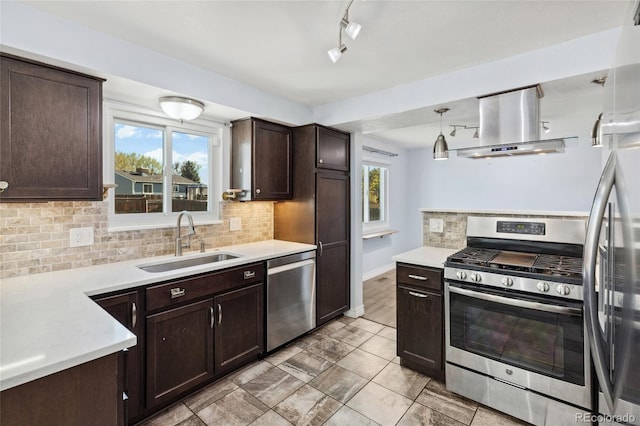4860 S Field Way, Littleton, CO 80123 - kitchen with appliances with stainless steel finishes, wall chimney range hood, dark brown cabinets, and backsplash