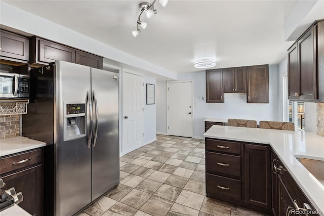 4860 S Field Way, Littleton, CO 80123 - kitchen featuring appliances with stainless steel finishes, dark brown cabinets, light countertops, and decorative backsplash