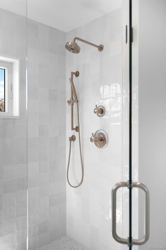 bathroom featuring a shower with shower door