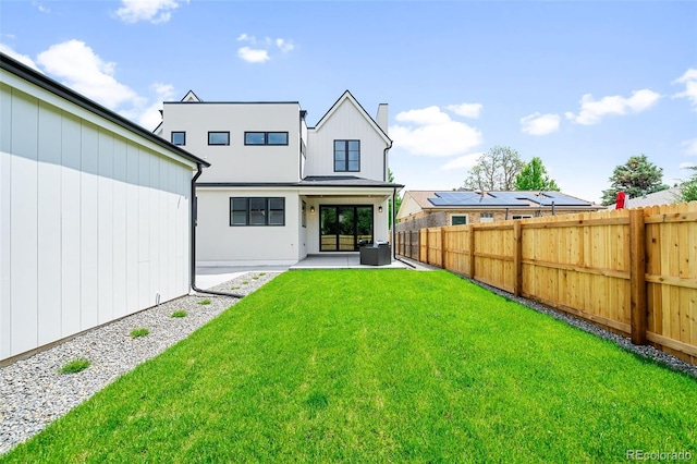 back of property featuring a lawn and a patio area