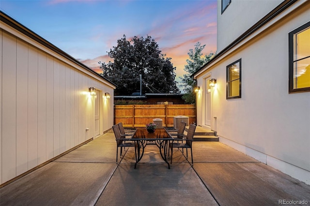 patio terrace at dusk featuring central air condition unit