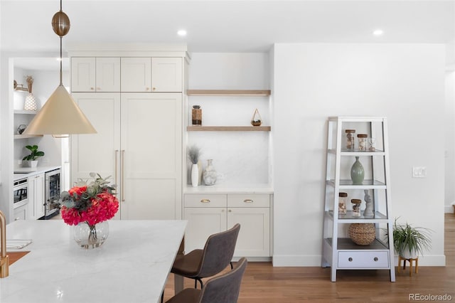 dining space featuring dark wood-type flooring and beverage cooler