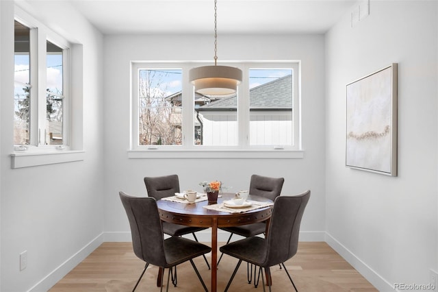 dining area featuring light wood-type flooring